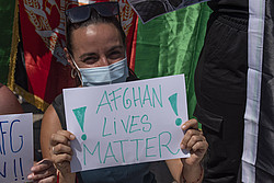 Eine Frau hält ein Demonstrationsschild mit der Aufschrift: "Afghan lives matter".